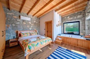 a bedroom with a bed and a bath tub at Villa Vareste & Villa Taş Mahal in Fethiye