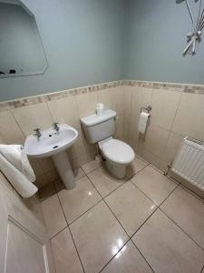 a bathroom with a toilet and a sink at Lily’s Town House in Buncrana