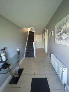 a hallway with a staircase in a house at Lily’s Town House in Buncrana