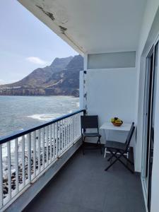 a balcony with a table and chairs and the ocean at Bajamar,un lugar mágico in Bajamar