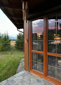 a window of a house with a view of a field at Lake View Home in Rajgród