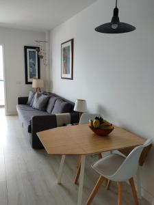 a living room with a table and a couch at Bajamar,un lugar mágico in Bajamar