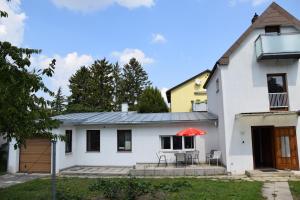 a white house with a patio in front of it at Central-Vintage Villa with free Parking and 5min walk to Metro in Vienna