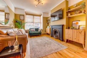 a living room with a couch and a fireplace at Boho Beach House: Hot Tub in Cleethorpes