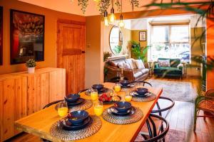 a table with plates of food on it in a living room at Boho Beach House Hot Tub, 3 Bedroom in Cleethorpes
