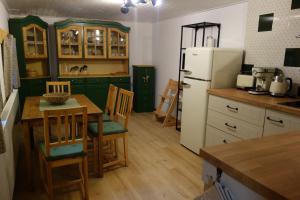 a kitchen with a table and a refrigerator at Rábenka in Janov nad Nisou