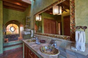 a bathroom with two sinks and a large mirror at Casa Puesta del Sol w/views slps 8 3 bths 3 bed in San Miguel de Allende