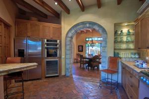 a kitchen with an archway and a dining room at Casa Puesta del Sol w/views slps 8 3 bths 3 bed in San Miguel de Allende