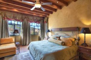 a bedroom with a large bed and a ceiling fan at Casa Puesta del Sol w/views slps 8 3 bths 3 bed in San Miguel de Allende