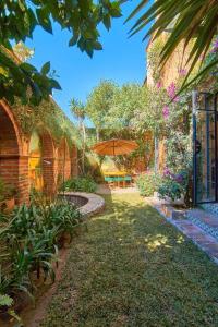 a patio with an umbrella in a yard with a house at Casa Puesta del Sol w/views slps 8 3 bths 3 bed in San Miguel de Allende