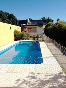 a swimming pool in front of a house at Casa Alquiler Temporario in Tandil