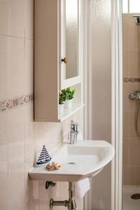 a bathroom with a sink and a mirror and a shower at Casa Siroco Sol in Playa Honda +38 photos