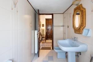 a bathroom with a sink and a toilet and a mirror at Zenios Dionysos - Traditional villa in Grevena +86 photos