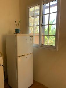 a white refrigerator in a room with a window at Hostal Aguas Verdes in Santa Catalina