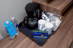 a counter with a coffee maker and cups on it at Hampton Inn By Hilton Tijuana in Tijuana