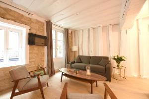 a living room with a couch and a table at Cosy flat - Saint germain in Paris