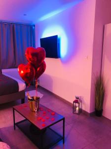 a living room with red balloons on a table at Appart&Spa République in Dijon