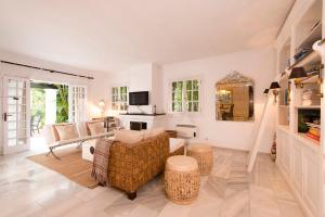 ein Wohnzimmer mit einem Sofa und einem Tisch in der Unterkunft Villa in a palm tree plantation in Marbella