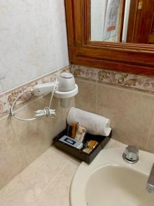 a bathroom with a white sink and a mirror at Hotel Real de la Sierra in Mazamitla
