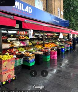 a fruit stand with fruits and vegetables on display at 13 Vale House in London