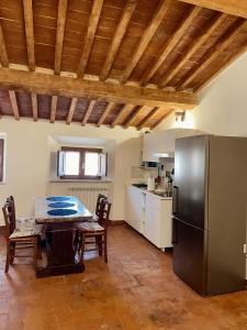 La cuisine est équipée d'une table et d'un réfrigérateur en acier inoxydable. dans l'établissement Modì Loft, à Livourne