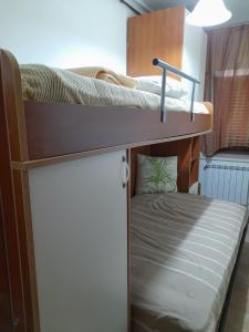 two bunk beds in a small room with a bed at Gabriella in SantʼEufemia a Maiella
