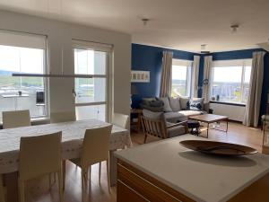 a kitchen and living room with a table and chairs at Pent house dublex with amazing city and Ocean views for 4 rooms 6 people in Reykjavík