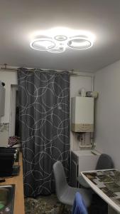 a kitchen with a black and white curtain and a table at Apartament Turda Cristina in Turda