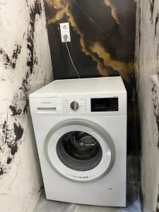 a washing machine in a corner of a room at Pension Gergert Gundelsheim in Gundelsheim