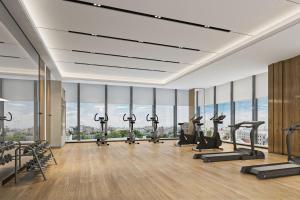 a gym with a row of treadmills and ellipticals at Fairfield by Marriott Zibo in Zibo