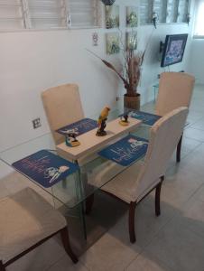a glass table with two chairs and a toy on it at El Yunque White House in Rio Grande