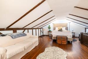 a living room with two beds and a couch at Bethel Woods Retreat - wPool, Hot Tub & Arcade! in Mongaup Valley +40 photos