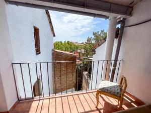 a balcony with a chair and a view of a building at Casa Yama - Renovated House in the Center of Berga in Berga