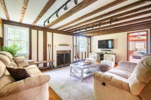 a living room with two couches and a fireplace at Bethel Woods Retreat - wPool, Hot Tub & Arcade! in Mongaup Valley