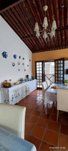 a kitchen with a table and chairs in a room at Flor de Lótus Suites in Tamandaré