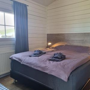 a bedroom with a bed with towels on it at Cosy cottage in the countryside in Þingeyjarsveit