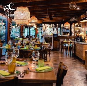 a restaurant with tables and chairs and a bar at Luxury B&B La Spelunca in Santa Maria Capua Vetere