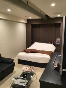 Postel nebo postele na pokoji v ubytování ホテルルミエール
