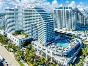 an aerial view of a large building with a pool at Beachfront Luxury 2BR 2BA, Sleeps 6, Resort Access - Horizon by HomeStakes in Fort Lauderdale