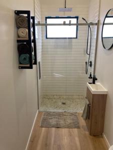 a bathroom with a shower and a sink at Harmony at the Heads in Mangawhai