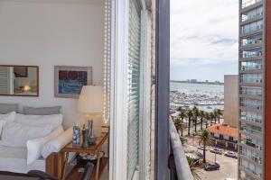 Un dormitorio con una cama y vistas a una ciudad. en Oceana Suites Lafayette, en Punta del Este