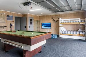 a room with a pool table and a bunk bed at Hillside Haven, House and Unit, Spa Pool in Raglan