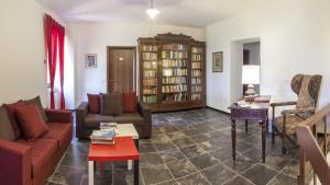 a living room with two couches and a table at Locanda Rossovino in Montebello