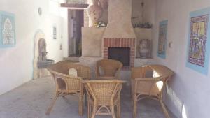 a room with a table and chairs and a fireplace at Casa Sisse in Càbras