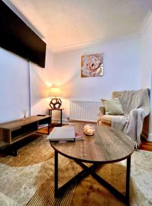 a living room with a table and a couch at City Signature Apartments in Cambridge