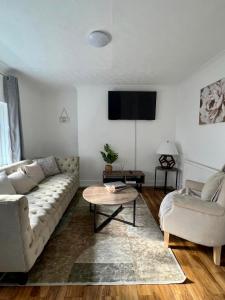 a living room with a couch and a table at City Signature Apartments in Cambridge