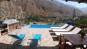 un patio con sedie e una piscina con montagne di Casa de Campo Sarita en huanchuy condominio a Archu