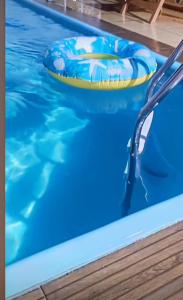 a swimming pool with a frisbee in the water at Flor de Lótus Suites in Tamandaré