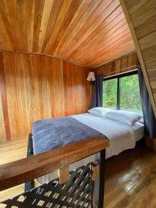 a bedroom with a bed and a wooden ceiling at Myra Chalets in Bijagua