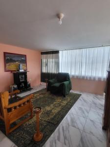 a living room with a couch and a window at Como en casa in Latacunga